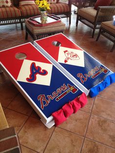 two bean bag tossers sitting on top of a tile floor