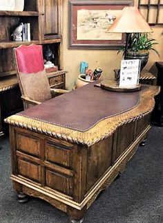 an office desk with a chair in front of it