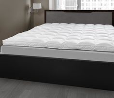 the mattress is made up and ready to be used in the bedroom or as a bed