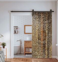 a bathroom with a gold shower curtain and wooden floors in front of the bathtub