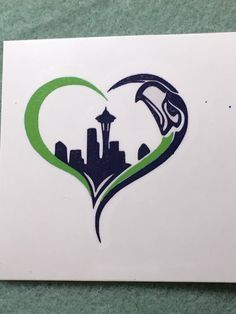 a heart shaped sticker with the seattle skyline in it's center is shown