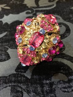 Gold plated ring with bright multi colored crystals on an adjustable band. Total must have!! Dome shaped design gives bling from all angles. Adjustable Multicolor Crystal Ring For Party, Vintage Multicolor Rings For Party, Pink Jeweled Rings For Party, Multicolor Party Ring Jewelry, Pink Jeweled Party Rings, Multicolor Crystal Rings For Party, Crystal Jeweled Party Rings, Jeweled Crystal Ring For Party, Multicolor Jeweled Ring