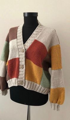 a mannequin wearing a multicolored cardigan sweater