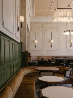 an empty restaurant with wooden booths and tables