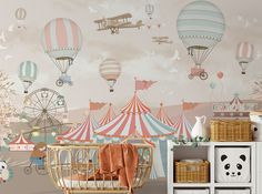 a baby's room decorated in pink, blue and white with hot air balloons