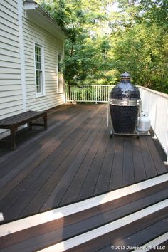 a bbq grill sitting on top of a wooden deck