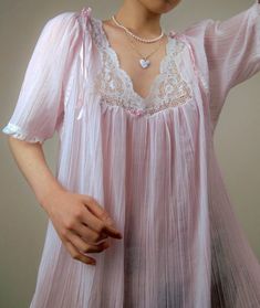 A delicate vintage pastel pink nightgown by designer, Christian Dior - Dainty lace and ribbon detailing along the neckline, sleeves, and hem - Entire gown is constructed from a delicate, pleated, and sheer plisse cotton blend fabric - Era: Circa 1970s - Condition: Excellent - Size: Medium - Color: Pastel pink, white Measurements: - 21.5in pit to pit - 53in garment length - 12.5 sleeve length Fabric Content: - 65% polyester, 35% cotton Shown on a mannequin with a 33" bust, 26" waist, and 35" hips. Fits a size 2-4. Model is 5'5 with a 34A bust. Some garments may be clipped onto mannequin or model for display. Thank you for visiting! Visit my official website, ariessencebyariel.com, for more! Vintage Bustier, Pink Nightgown, Vintage Hollywood Glamour, Vintage Christian Dior, Color Pastel, Women's Nightgowns, Pretty Lingerie, Mode Inspo, Nightgowns