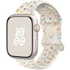 an apple watch with colorful sprinkles on the front and white band,