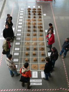 several people standing around a table that has cookies on it