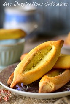 there is a plate with some cookies on it and lavenders in the bowl next to it