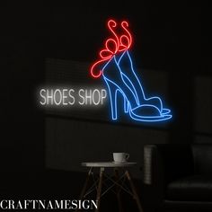 a neon sign that says shoes shop on the side of a wall next to a chair