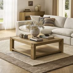 a living room with a white couch and coffee table