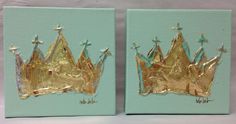 two gold crowns sitting on top of each other in front of a blue wall with white writing