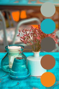 a vase filled with flowers sitting on top of a blue table covered in polka dots