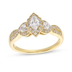 a yellow gold ring with diamonds on the sides and an oval shaped diamond in the center