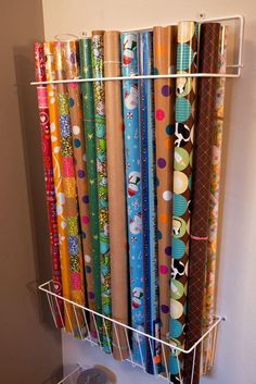 several rolls of wrapping paper are hanging on the wall