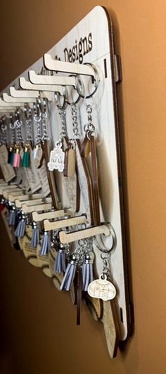 a bunch of keys are hanging on a key holder that is attached to a wall