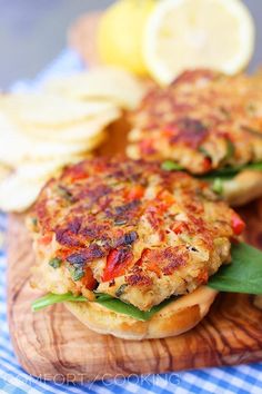 two crab cakes on top of a wooden cutting board with text overlay that reads yum crab and corn cakes with a spicy mayo recipe