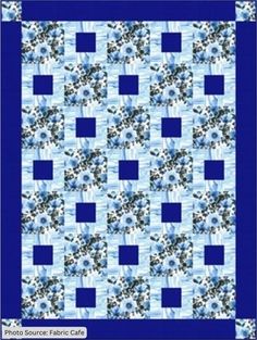 a blue and white quilt with flowers on it