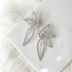 Lorelei Floral Statement Earrings are sparkly, eye-catching earrings that will grab everyone’s attention with sensual lines studded with rhinestones. About 4 inches at its longest, 2 inches at its widest This is a special occasion item = FINAL SALE Sparkling Cubic Zirconia Bridal Earrings For Party, Diamond White Bridal Earrings With Diamond Accents For Parties, Dazzling Diamond White Crystal Earrings For Party, Diamond White Sparkling Crystal Earrings For Party, Diamond White Crystal Earrings With Bling For Party, Party Bridal Drop Earrings With Diamond Accents, Sparkling Diamond White Crystal Earrings For Party, Sparkling Diamond White Crystal Party Earrings, Diamond White Earrings With Diamond Accents For Party