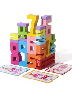 the colorful wooden blocks have numbers on them and are next to two matching cards for each letter