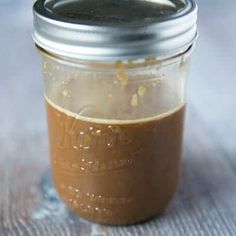 a jar filled with brown liquid sitting on top of a table