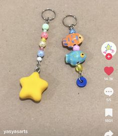 two keychains with different designs and colors on them, one has a star