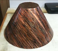 a brown lamp shade sitting on top of a counter