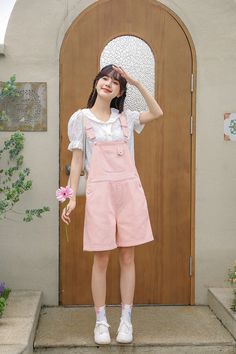 Extra sweet pink overalls with heart buttons, now in a shorter length for warmer days. Features a high waist boyfriend fit with roomy legs, side pockets and back pockets. S: 32" waist, 40" hips, 12" rise, 25" thighs, 6" inseamM: 33.5" waist, 41.5" hips, 12" rise, 26" thighs, 6" inseamL: 35" waist, 43" hips, 12" rise, 27" thighs, 6" inseam How to attach buckles:Slide the rectangular buckle on first, followed by the T-shaped buckle. Overall straps will hold on its own as such or you can slide the free end back into the rectangular buckle. Cute Pink Bottoms With Pockets, Cute Spring Shortalls Overall, Cute Spring Shortalls Overalls, Cute Spring Overall Shortalls, Pink Shortalls For Summer, Pink Shortalls With Pockets, Trendy Pink Cotton Jumpsuits And Rompers, Pink Short Overalls For Summer, Spring Cute Bib Front Overalls