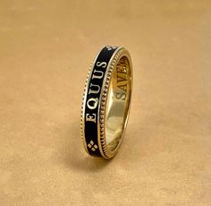 A slim stackable version of our Equus Enamel Ring. Beautiful combination of black enamel and 18 karat yellow gold. 4mm wide Equus (Latin for horse) Cheval (French for horse), stars and a snaffle bit in a continual pattern. Fine beaded detail on both edges. Absolutely gorgeous stacked with the Slim Lace Rein & Diamond Stack rings! Create your own combination! Hand made in the US Made to order, please allow 4-6 weeks for delivery. Luxury Antique Engraved Enamel Ring, Luxury Vintage Enamel Ring For Wedding, Luxury Formal Round Enamel Ring, Luxury Yellow Gold Elegant Enamel Ring, Luxury Black Enamel Anniversary Ring, Stack Rings, Snaffle Bit, Diamond Stacks, Enamel Ring