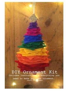 an ornament is hanging from a string in the shape of a rainbow christmas tree