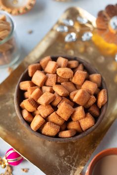 a bowl full of sugar cubes next to some orange slices and other candies