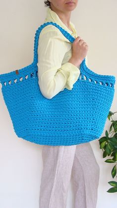 This huge crochet bag is a must-have for summer beach days. This lacey-accented boho chic basket bag goes great with a flimsy dress, short or long leggings, t-shirt, and sweater. It looks great as a summer accessory, beach bag, or everyday bag. It can accommodate books, beach gear, children's possessions, or groceries. Also makes a terrific gift! #custombasketbag #largetotebag #beachbag Bohemian Crochet Bag For Beach Shopping, Summer Crochet Bag For Shopping, Crochet Straw Bag For Beach Shopping, Crochet Straw Bag For Shopping In Beach Season, Crochet Straw Bag For Beach Season Shopping, Straw Crochet Bag For Shopping During Beach Season, Summer Beach Crochet Macrame Bag, Crochet Straw Bag For Shopping During Beach Season, Summer Macrame Straw Bag