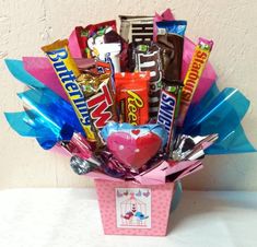 a pink box filled with candy and candies