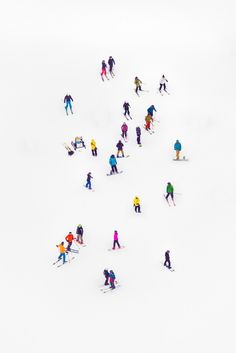 a group of people riding skis down a snow covered slope