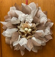 a wreath made out of burlocks on the front door