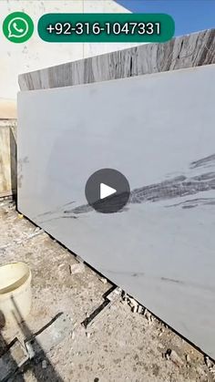 a white marble slab being installed on the ground