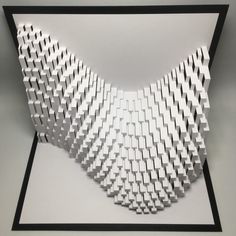 an art piece made out of white cubes on a gray background with black frame