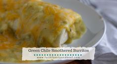 green chile smothered burritos on a white plate