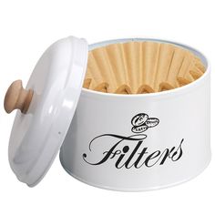 a white canister filled with wooden sticks