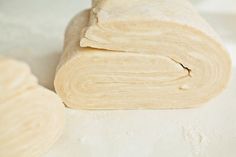 rolled up dough sitting on top of a white counter