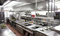 an industrial kitchen with stainless steel appliances and counters