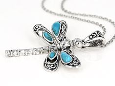 Southwest Style By JTV™ Turquoise Rhodium Over Silver Dragonfly Enhancer With 18" Chain. Measures approximately 1.79"L x 1.56"W. 5.3mm bail. 2" extender. Turquoise Stainless Steel Jewelry As Gift, Turquoise Stainless Steel Jewelry As A Gift, Turquoise Stainless Steel Jewelry Gift, Elegant Sterling Silver Dragonfly Jewelry, Dragonfly Necklace Silver, Sterling Silver Dragonfly Necklace, Nickel-free Adjustable Dragonfly Jewelry, Nickel-free Blue Dragonfly Jewelry, Bullet Casing Jewelry