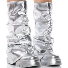 The Azalea Wang " Combat Beauty " Metallic Mid Calf Boot In Silver Is Made From A Metallic Faux Leather Upper And Features A Scrunched Foldover Mid Calf-Height Shaft, And A Chunky Covered Flatform Sole. Complete With A Rounded Toe And Pull-On Fit. - Pu Upper - Mid Calf-Height Shaft - Rounded Toe - Flatform Sole - 12” Shaft Height - 17" Calf Circumference - 2.5” Heel Height - Imported Metallic Futuristic Fashion, Black And Silver Boots, Silver Synthetic Boots With Round Toe, Metallic Leather Boots With Round Toe, Silver Metallic Boots, Chrome Clothes, Chrome Boots, Armor Boots, Album Concept