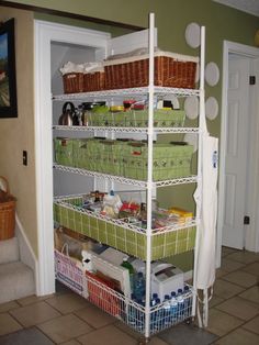 an image of a closet with baskets on the bottom shelf and other items in it