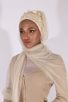 Complete your look with this stunning cream turban veil. Our Mystery in Cream Veil presents this magnificently embroidered turban to frame your face for a distinctive look. The one-piece turban veil is made especially for a simple yet classy fit that you can do yourself. The 58” long veil has a light cream shade to brighten up your dress.Whether it’s your wedding or engagement party, this turban veil will surprisingly shine up your special day and wow your guests.The turban's embroidery is based White Headscarf For Wedding, Elegant White Headscarf For Wedding, Elegant White Wedding Headscarf, Elegant White Headwrap Headband, Elegant White Headband Headwrap, Fitted Headscarf For Wedding, Elegant Fitted White Turban, Elegant White Fitted Turban, Traditional White Hijab For Wedding