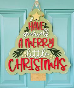 a sign that says have yourself a merry little christmas hanging on a door with a star