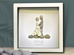 a couple is holding each other while standing in front of some rocks with the words happy new year written on them