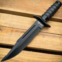 a black knife sitting on top of a wooden table