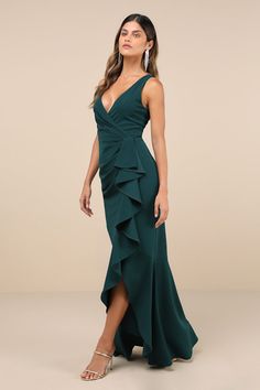 We can't imagine a better way to look truly elegant than with the Lulus Pure Loveliness Emerald Pleated Ruffled High-Low Maxi Dress! This sensational, crepe knit gown features a lightly pleated bodice and a flirty surplice neckline (and V-back), all supported by wide shoulder straps. Flouncy ruffle trim starts at the high, fitted waist and continues down the figure-flaunting skirt as it falls to a trendy, high-low maxi hem. Hidden back zipper/clasp. Fit: This garment fits true to size. Length: F Elegant V-neck Maxi Dress With Ruffled Skirt, Elegant Green V-neck Ruffle Dress, Elegant Maxi Length Gown With Ruffles, Elegant Maxi Gown With Ruffles, V-neck Gown With Ruffles For Evening, Elegant Ruffle Dress With Maxi Length, Elegant Maxi Ruffle Dress For Wedding, Elegant Maxi Length Ruffle Dress, Elegant Maxi Ruffle Dress With Ruffled Skirt